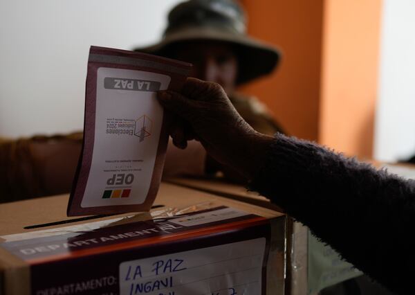 An Aymara woman casts her ballot during judicial elections in Guaqui, Bolivia, Sunday, Dec. 15, 2024. (AP Photo/Juan Karita)