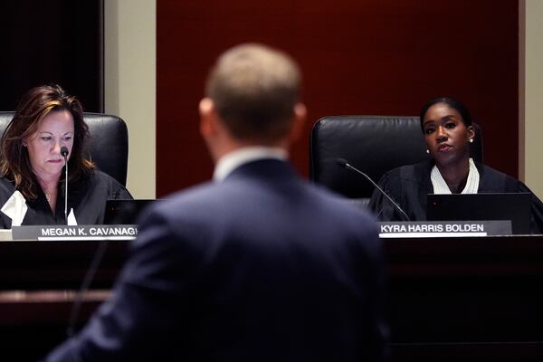 Justices of the Michigan Supreme Court Megan K. Cavanagh, left, and Kyra Harris Bolden listen to oral arguments at the Michigan Hall of Justice, Wednesday, Dec. 4, 2024, in Lansing, Mich. (AP Photo/Carlos Osorio)