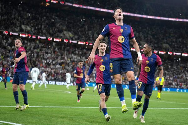 Barcelona's Robert Lewandowski celebrates after scoring his side's second goal during the Spain Super Cup final soccer match between Real Madrid and Barcelona at King Abdullah Stadium in Jeddah, Saudi Arabia, Sunday, Jan. 12, 2025. (AP Photo/Altaf Qadri)