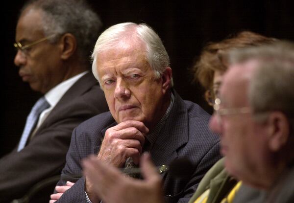 FILE - Former President Jimmy Carter, center, listens to a speech by former President of Costa Rica Rodrigo Carazo Odio, right, at the opening of the Joan B. Kroc Institute For Peace and Justice on the campus of the University of San Diego, in San Diego, on Dec. 6, 2001. (AP Photo/Denis Poroy, File)