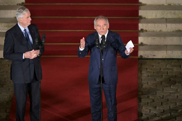 France's newly appointed Prime Minister Francois Bayrou, right, speaks as outgoing Prime minister Michel Barnier listens after the handover ceremony at the Hotel Matignon , the Prime Minister residence, in Paris, Friday Dec. 13, 2024.( Bertrand Guay/ Pool via AP)