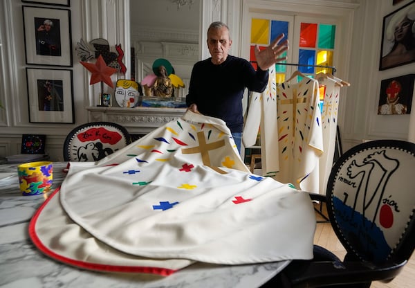 Designer Jean-Charles de Castelbajac displays a liturgical vestment for bishops to be worn at the reopening of Paris' Notre Dame Cathedral in December during an interview with the Associated Press Wednesday, Nov. 20, 2024 in Paris. (AP Photo/Michel Euler)