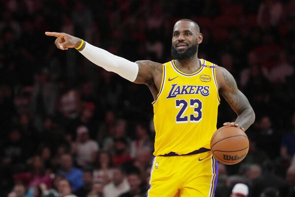 Los Angeles Lakers forward LeBron James gestures during the first half of an NBA basketball game against the Miami Heat, Wednesday, Dec. 4, 2024, in Miami. (AP Photo/Marta Lavandier)