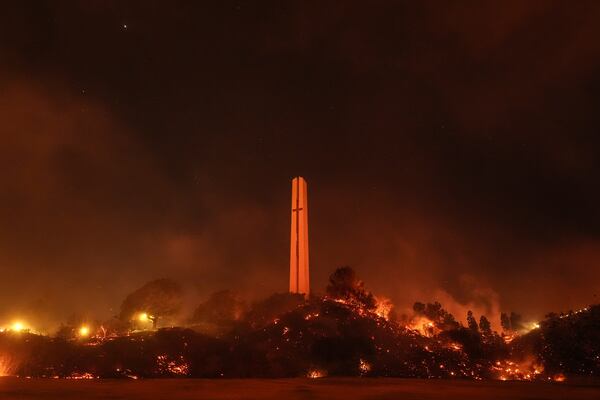 Vegetation around the Phillips Theme Tower at Pepperdine University is scorched by the Franklin Fire in Malibu, Calif., Tuesday, Dec. 10, 2024. (AP Photo/Jae C. Hong)