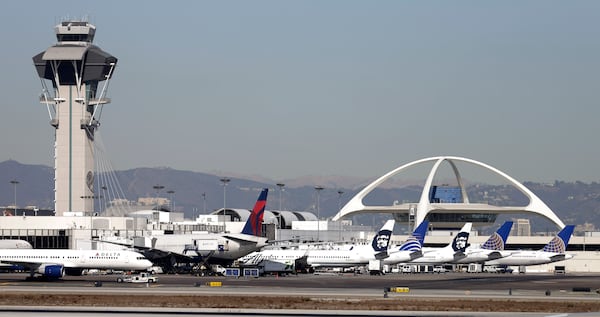 FILE - Airplanes sit on the tarmac at Los Angeles International Airport Friday, Nov. 1, 2013. (AP Photo/Gregory Bull, File)