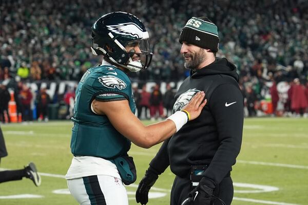 Philadelphia Eagles quarterback Jalen Hurts (1) celebrates with coach Nick Sirianni during the second half of the NFC Championship NFL football game against the Washington Commanders, Sunday, Jan. 26, 2025, in Philadelphia. (AP Photo/Matt Slocum)