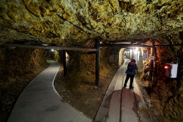 A visitor walk through tunnels at Sado Kinzan Gold Mine historic site in Sado, Niigata prefecture, Japan, Sunday, Nov. 24, 2024. (AP Photo/Eugene Hoshiko)