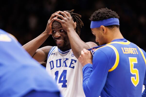 Duke's Sion James (14) reacts to teammate Cooper Flagg's dunk during the second half of an NCAA college basketball game against Pittsburgh in Durham, N.C., Tuesday, Jan. 7, 2025. (AP Photo/Ben McKeown)