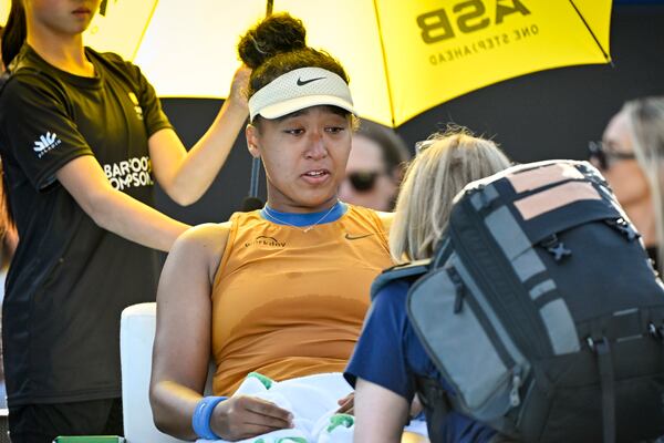 Naomi Osaka of Japan receives medical attention during her match against Clara Tauson of Denmark in the finals singles match of the ASB Classic tennis tournament at Manuka Doctor Arena in Auckland, New Zealand, Sunday, Jan. 5, 2025. (Alan Lee/Photosport via AP)