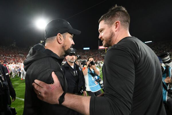 Ohio State head coach Ryan Day, left, and Oregon head coach Dan Lanning meet after the quarterfinals of the Rose Bowl College Football Playoff, Wednesday, Jan. 1, 2025, in Pasadena, Calif. (AP Photo/Kyusung Gong)