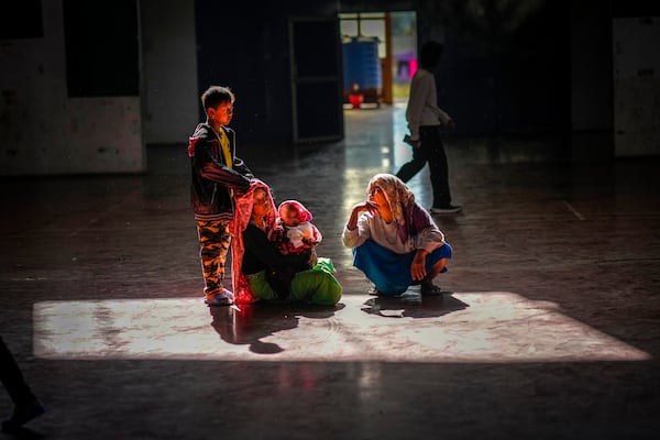 A Meitei family sits in a relief camp in Imphal, Manipur, Monday, Dec. 16, 2024. (AP Photo/Anupam Nath)