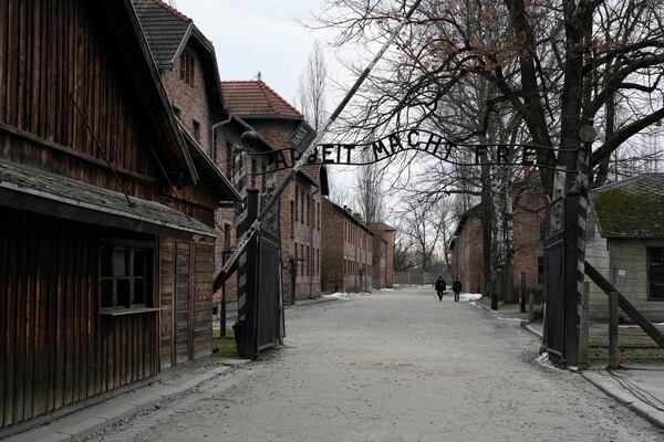 People visit the Memorial and Museum Auschwitz-Birkenau, a former Nazi German concentration and extermination camp, in Oswiecim, Poland, Sunday, Jan. 26, 2025. (AP Photo/Czarek Sokolowski)