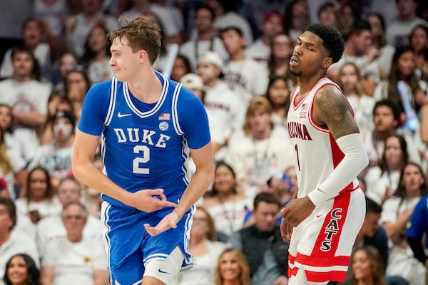 Duke guard Cooper Flagg (2) gestures after scoring against Arizona guard Caleb Love (1) during the second half of an NCAA college basketball game Friday, Nov. 22, 2024, in Tucson, Ariz. (AP Photo/Darryl Webb)