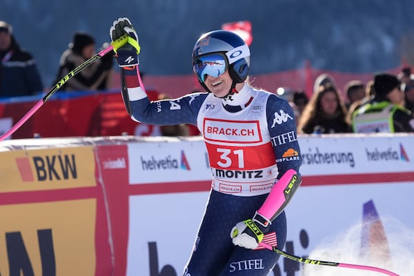 United States' Lindsey Vonn celebrates at the finish area of an alpine ski, women's World Cup super G, in St. Moritz, Switzerland, Saturday, Dec. 21, 2024. (AP Photo/Giovanni Auletta)