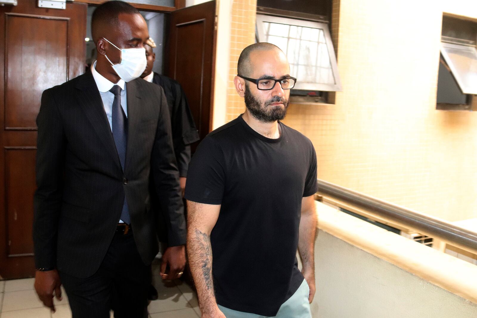 FILE - Tigran Gambaryan, an American citizen and Binance's head of financial crime compliance, right, is escorted as he leaves a court hearing at the federal High Courts, in Abuja, Nigeria, April 4, 2024. (AP Photo/Olamikan Gbemiga, File)