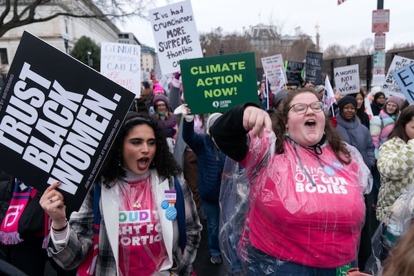 Demonstrators walk on there street as they protest during the People's March, Saturday, Jan. 18, 2025, in Washington. (AP Photo/Jose Luis Magana)