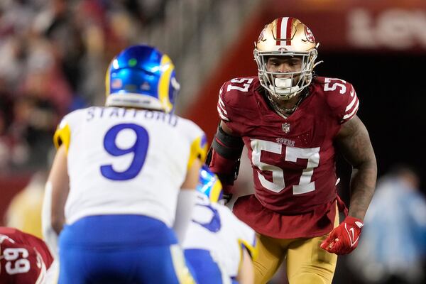 San Francisco 49ers linebacker Dre Greenlaw (57) watches as Los Angeles Rams quarterback Matthew Stafford (9) stands behind center during the second half of an NFL football game in Santa Clara, Calif., Thursday, Dec. 12, 2024. (AP Photo/Godofredo A. Vásquez)