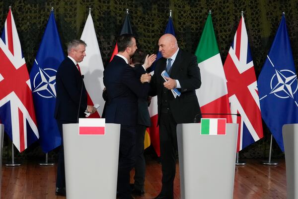 From left: Luke Pollard, Parliamentary Under-Secretary of State in the Britain's Ministry of Defence, Poland's Minister of National Defence Wladyslaw Kosiniak-Kamysz, and Italy's Minister of Defence Guido Crosetto greet each other after a meeting of defense ministers of five NATO countries to discuss coordinating their defense plans and support for Ukraine, in the village of Helenow, near Warsaw, Poland, Monday, Jan. 13, 2025. (AP Photo/Czarek Sokolowski)