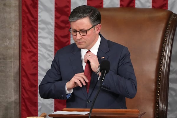 House Speaker Mike Johnson, R-La., adjusts his tie as the House of Representatives meets to elect a speaker and convene the new 119th Congress at the Capitol in Washington, Friday, Jan. 3, 2025. (AP Photo/Jacquelyn Martin)