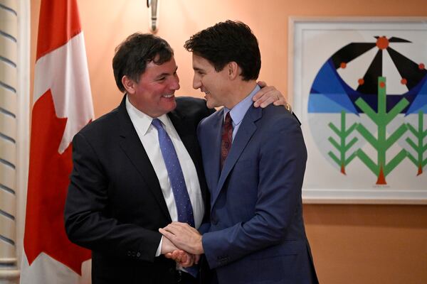 Prime Minister Justin Trudeau, right, congratulates Dominic LeBlanc, left, after LeBlanc was sworn in as finance minister at a ceremony at Rideau Hall in Ottawa, Ontario, Monday, Dec. 16, 2024. (Justin Tang/The Canadian Press via AP)