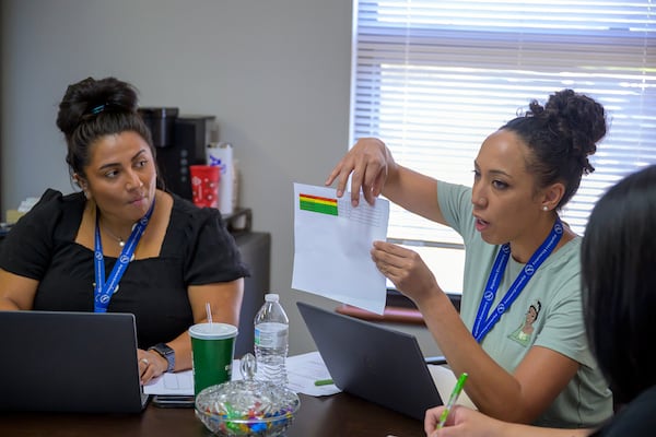 Social worker Mary Schmauss, left, and attendance clerk Katrice Grant, discussing truancy cases they need to tackle, Tuesday, Oct. 1, 2024, at Algodones Elementary School in Algodones, N.M. (AP Photo/Roberto E. Rosales)