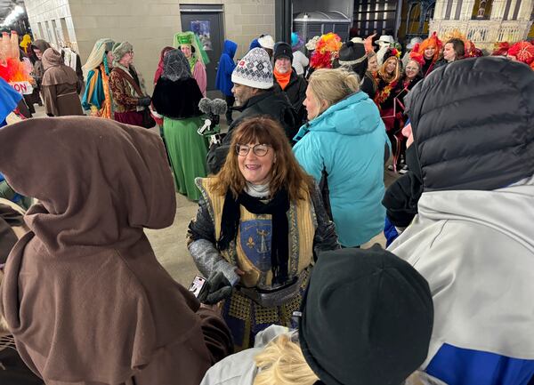 Antoinette de Alteriis, co-captain of the Krewe de Jeanne d'Arc, organizes volunteers before the start of the Joan of Arc parade on Monday, Jan. 6, 2025, in New Orleans. (AP Photo/Jack Brook)