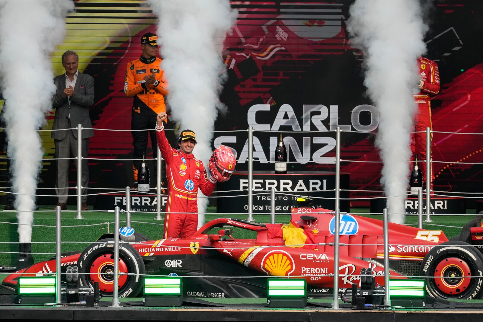 Ferrari driver Carlos Sainz of Spain celebrates after winning the Formula One Mexico Grand Prix auto race at the Hermanos Rodriguez racetrack in Mexico City, Sunday, Oct. 27, 2024. (AP Photo/Eduardo Verdugo)