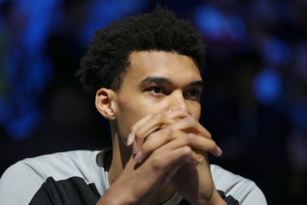 San Antonio Spurs center Victor Wembanyama sits before a Paris Games 2025 NBA basketball game against the Indiana Pacers in Paris, Thursday, Jan. 23, 2025. (AP Photo/Thibault Camus)