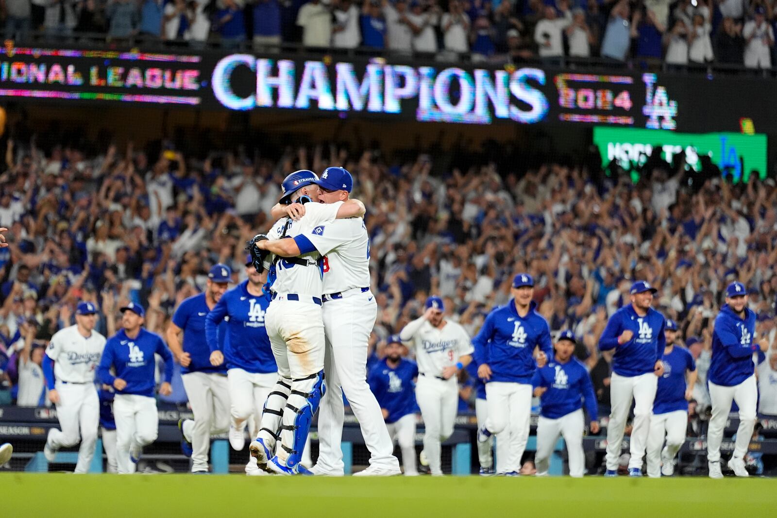 Los Angeles Dodgers pitcher Blake Treinen and catcher Will Smith celebrate their win against the New York Mets in Game 6 of a baseball NL Championship Series, Sunday, Oct. 20, 2024, in Los Angeles. The Dodgers will face the New York Yankees in the World Series. (AP Photo/Julio Cortez)