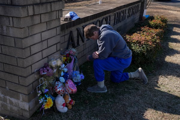 Kristi Rainwater kneels in prayer at a memorial for victims of a shooting at Antioch High School, Thursday, Jan. 23, 2025, in Nashville, Tenn. (AP Photo/George Walker IV)