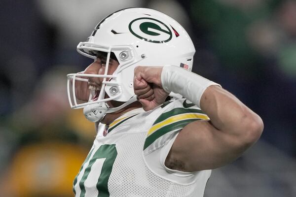 Green Bay Packers' Jordan Love celebrates a touchdown during the first half of an NFL football game against the Seattle Seahawks Sunday, Dec. 15, 2024, in Seattle. (AP Photo/Stephen Brashear)