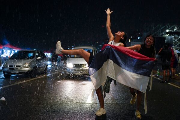 Supporters of the Frente Amplio (Broad Front) celebrate the victory of candidate Yamandú Orsi in the presidential run-off election in Montevideo, Uruguay, Nov. 24, 2024. (AP Photo/Natacha Pisarenko)