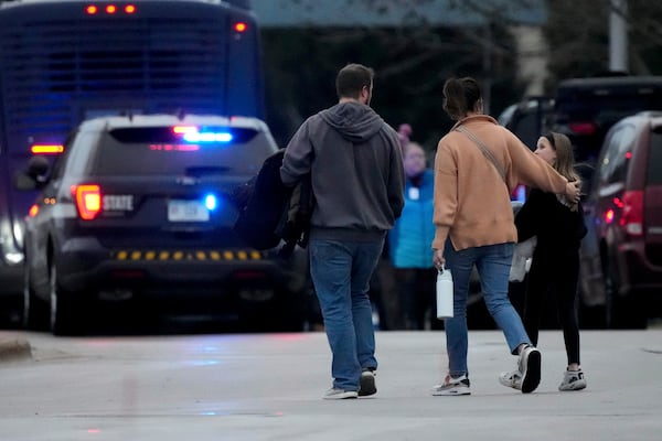 Families leave the SSMI Health Center, set up as a reunification center, following a shooting, Monday, Dec. 16, 2024 in Madison, Wis. (AP Photo/Morry Gash)