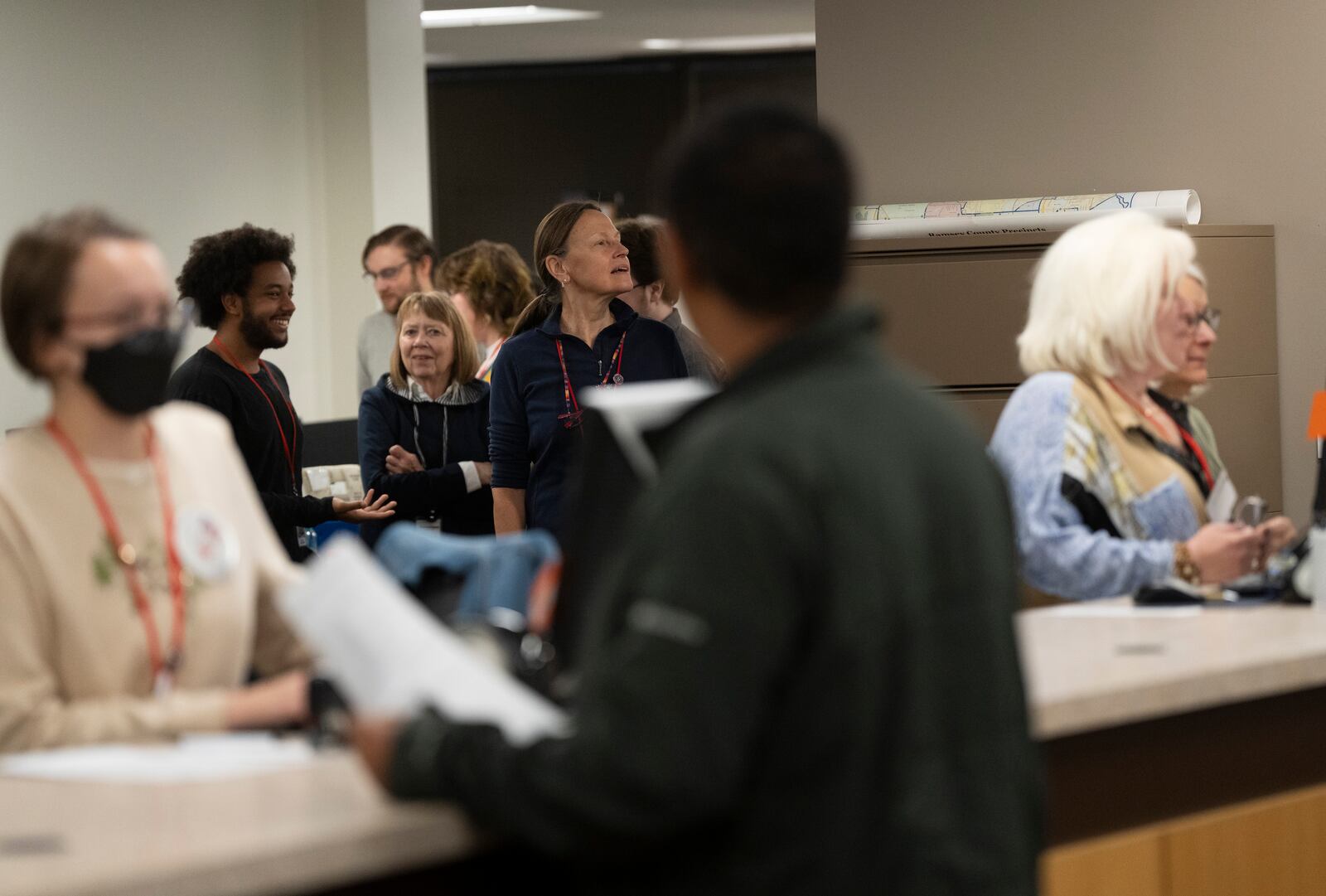 Staff at Ramsey County Elections try to get a look at Minnesota Governor and Vice Presidential candidate Tim Walz as he early votes in St. Paul, Minn., on Wednesday, October 23, 2024. (Renée Jones Schneider/Star Tribune via AP)