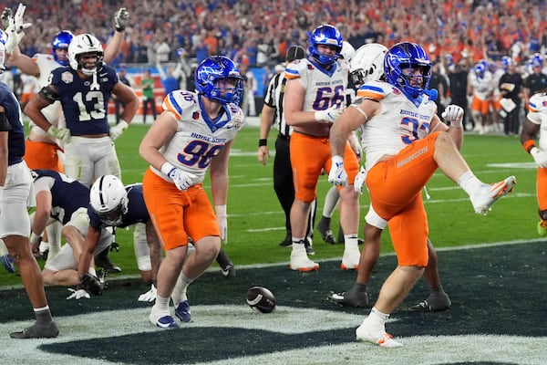 Boise State fullback Tyler Crowe (33) celebrates his touchdown against Penn State during the first half of the Fiesta Bowl NCAA college football CFP quarterfinal game, Tuesday, Dec. 31, 2024, in Glendale, Ariz. (AP Photo/Ross D. Franklin)