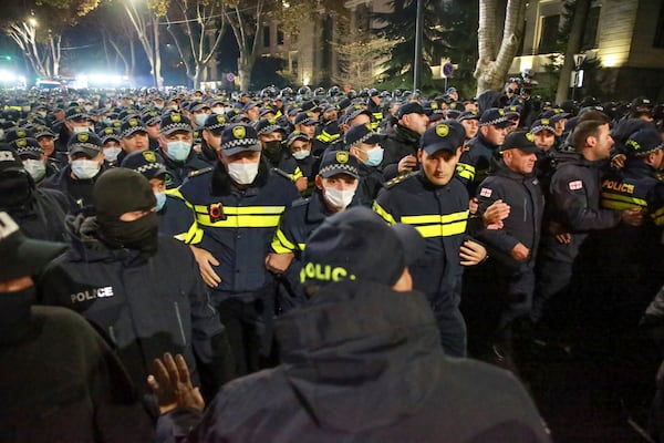 Police block a street during a rally against the results of the parliamentary elections amid allegations that the vote was rigged in Tbilisi, Georgia Tuesday, Nov. 19, 2024. (AP Photo/Zurab Tsertsvadze)