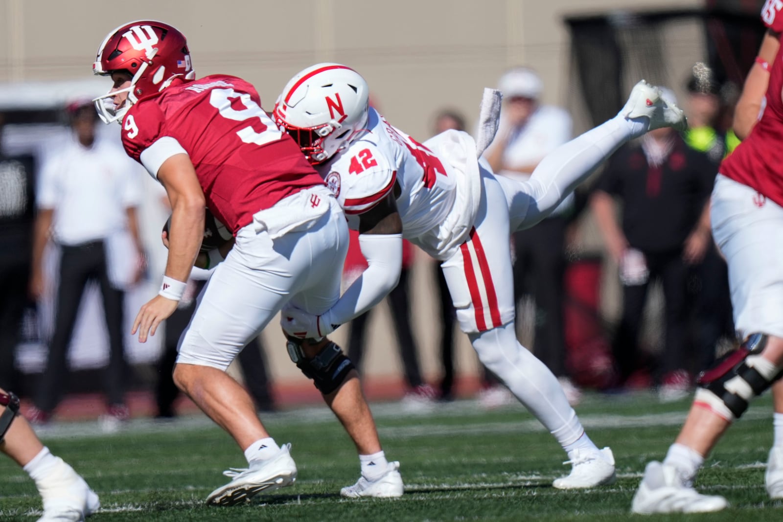 Indiana quarterback Kurtis Rourke (9) gets sacked by Nebraska linebacker Mikai Gbayor (42) during the first half of an NCAA college football game in Bloomington, Ind., Saturday, Oct. 19, 2024. (AP Photo/AJ Mast)