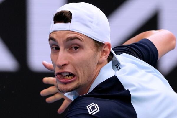 Ugo Humbert of France returns a shot from Alexander Zverev of Germany during their fourth round match at the Australian Open tennis championship in Melbourne, Australia, Sunday, Jan. 19, 2025. (AP Photo/Manish Swarup)