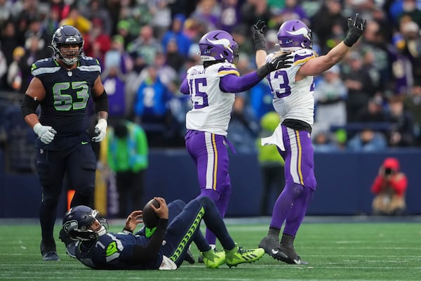 Minnesota Vikings linebacker Andrew Van Ginkel (43), right, celebrates after sacking Seattle Seahawks quarterback Geno Smith (7) during the second half of an NFL football game, Sunday, Dec. 22, 2024, in Seattle. (AP Photo/Lindsey Wasson)