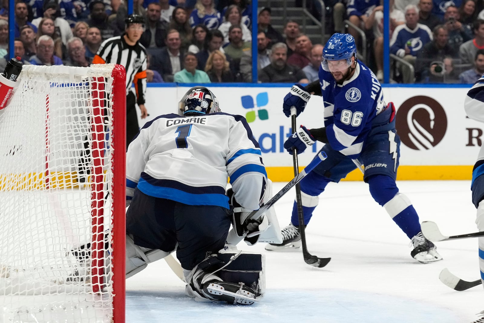 Tampa Bay Lightning right wing Nikita Kucherov (86) shoots on Winnipeg Jets goaltender Eric Comrie (1) during the second period of an NHL hockey game Thursday, Nov. 14, 2024, in Tampa, Fla. (AP Photo/Chris O'Meara)