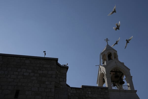 Birds fly above the Church of the Nativity, where Christians believe Jesus Christ was born, ahead of Christmas in the West Bank city of Bethlehem, Tuesday, Dec. 17, 2024. (AP Photo/Mahmoud Illean)