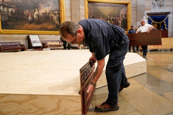 Workers build a stage in the U.S. Capitol Rotunda in Washington Friday, Jan. 17, 2025, for the 60th Presidential Inauguration which was moved indoors because of cold temperatures expected on Jan 20. (AP Photo/Morry Gash)