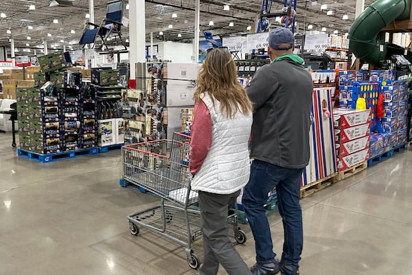 FILE - Shoppers pass displays of goods in a Costco warehouse Sunday, Feb. 25, 2024, in Sheridan, Colo. (AP Photo/David Zalubowski, File)