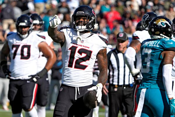 Houston Texans wide receiver Nico Collins (12) reacts after the Jacksonville Jaguars were called for a penalty during the first half of an NFL football game Sunday, Dec. 1, 2024, in Jacksonville, Fla. (AP Photo/John Raoux)