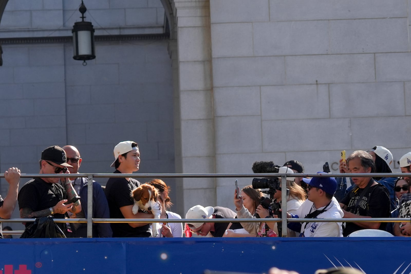 Los Angeles Dodgers' Shohei Ohtani holds his dog Decoy during the Los Angeles Dodgers baseball World Series championship parade Friday, Nov. 1, 2024, in Los Angeles. (AP Photo/Jae C. Hong)