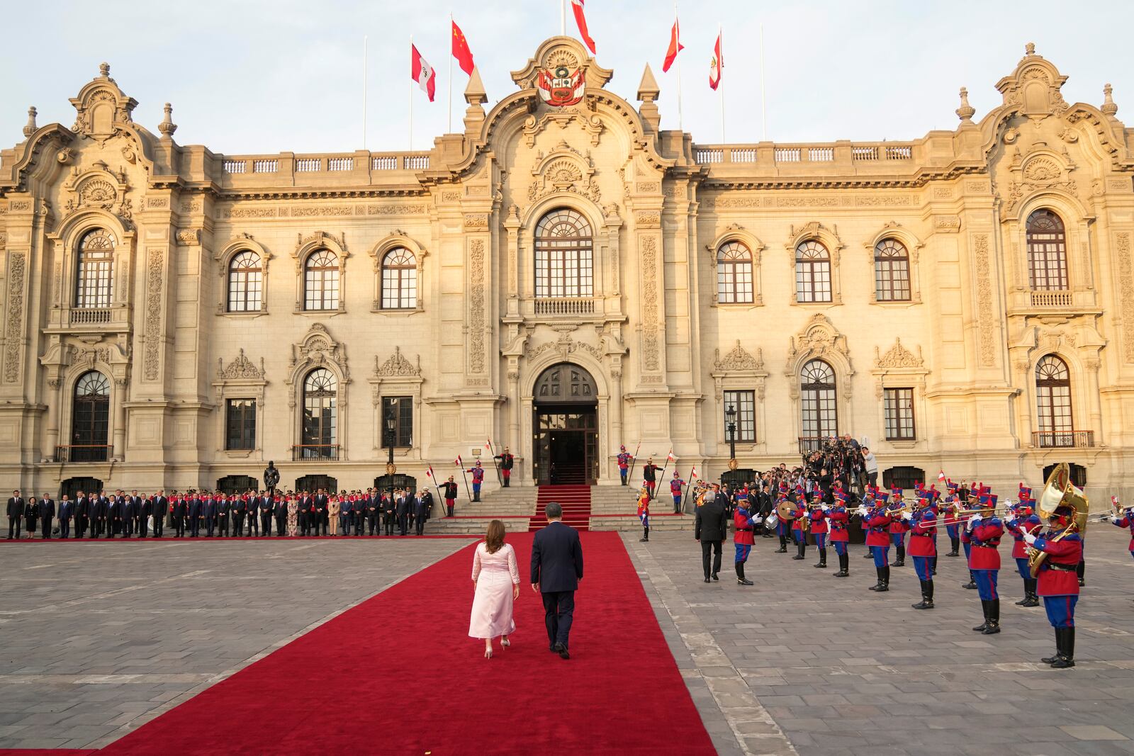 Peru's President Dina Boluarte, left, and Chinese President Xi Jinping walk down the red carpet during a welcome ceremony at the government palace in Lima, Peru, Thursday, Nov. 14, 2024, on the sidelines of the Asia-Pacific Economic Cooperation (APEC) summit. (AP Photo/Fernando Vergara)