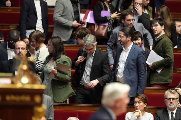 Leftist parliament members leave as French Prime Minister Michel Barnier delivers his speech at the National Assembly while France's minority government may be on its last legs as opposition lawmakers moved this week toward a no-confidence vote, Monday, Dec. 2, 2024 in Paris. (AP Photo/Michel Euler)