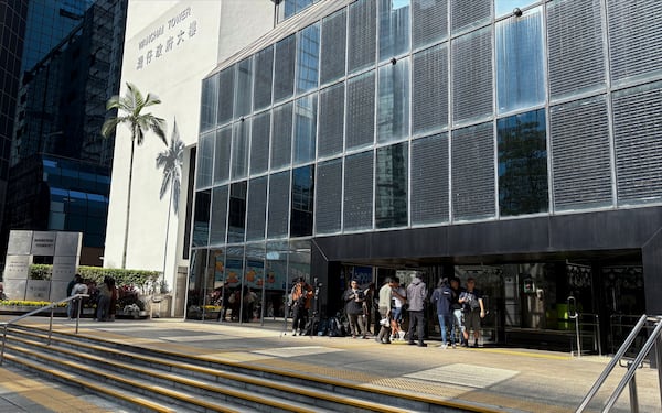 Journalists wait outside District Court in Wan Chai, Hong Kong, ahead of its verdicts on a landmark riot case involving a former pro-democracy lawmaker on Thursday, Dec. 12, 2024. (AP Photo/Kanis Leung)