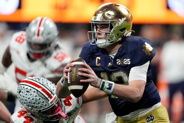 Notre Dame quarterback Riley Leonard is tackled by Ohio State defensive end JT Tuimoloau during first half of the College Football Playoff national championship game Monday, Jan. 20, 2025, in Atlanta. (AP Photo/Brynn Anderson)