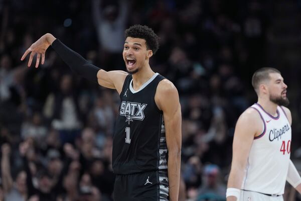 San Antonio Spurs center Victor Wembanyama (1) reacts to a score against the LA Clippers during the second half of an NBA basketball game in San Antonio, Wednesday, Jan. 29, 2025. (AP Photo/Eric Gay)